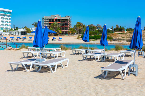 Summer Vacation at Ayia Napa Beach in Cyprus . Deck lounges at sandy beach