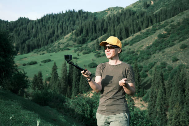 istock Mature vlogger is telling about her road trip in mountains 1497646660
