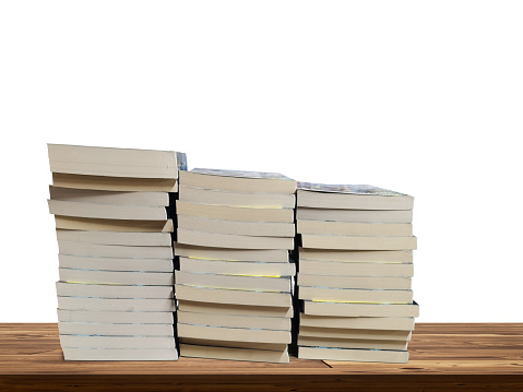 stack of books on wooden table isolated on white background