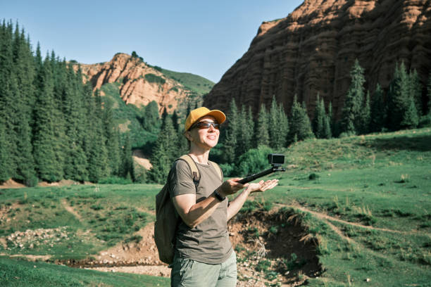 istock Mature vlogger is telling about her road trip in mountains 1497648333