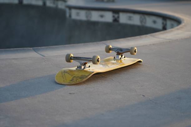 istock Yellow skateboard lying upside down on a skate track 1497653990