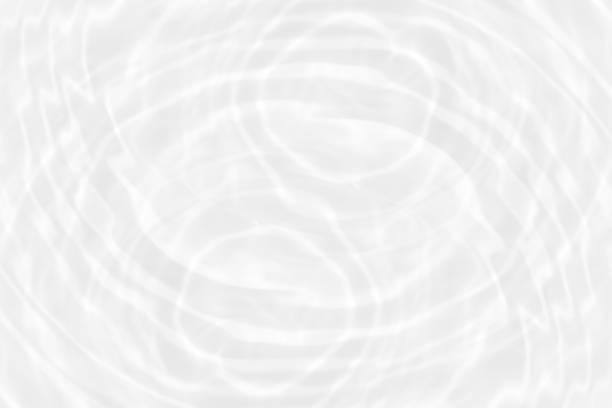 istock White water with ripples on the surface. Defocus blurred transparent white colored clear calm water surface texture with splashes and bubbles. Water waves with shining pattern texture background. 1497655341
