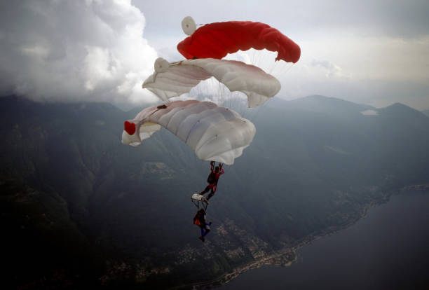 istock Skydive athletes perform above Swiss mountain landscape 1497655693