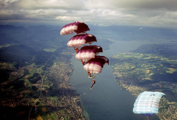 istock Skydive athletes perform above Swiss mountain landscape 1497655697