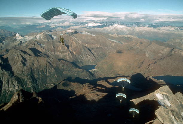 istock Skydive athletes perform above Swiss mountain landscape 1497655749