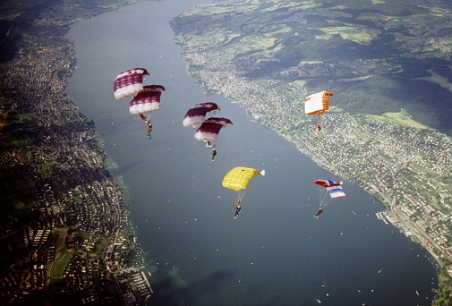 Parachutists jump from a vintage biplane, Rijeka, Croatia