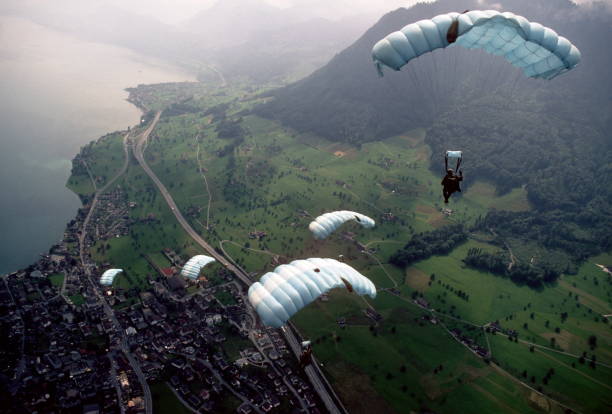 istock Skydive athletes perform above Swiss mountain landscape 1497656029