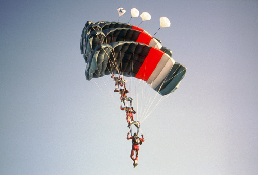 Paratroopers on coloured parachutes