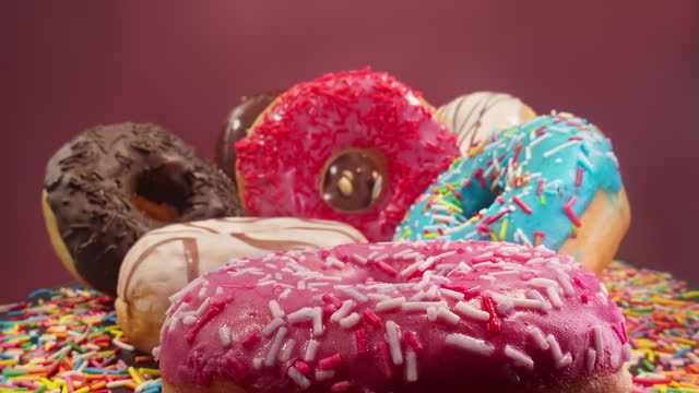 Probe lens passing through delicious colorful donuts. Donuts with colorful icing