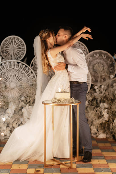 istock newlyweds happily cut and taste the wedding cake 1497658235