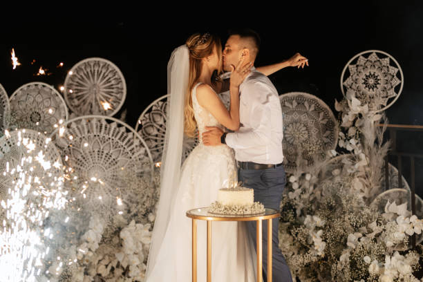 istock newlyweds happily cut and taste the wedding cake 1497659119