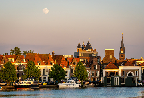 View of the Spaarne river and the tower of The Amsterdamse Poort city gate in Haarlem, The Netherlands