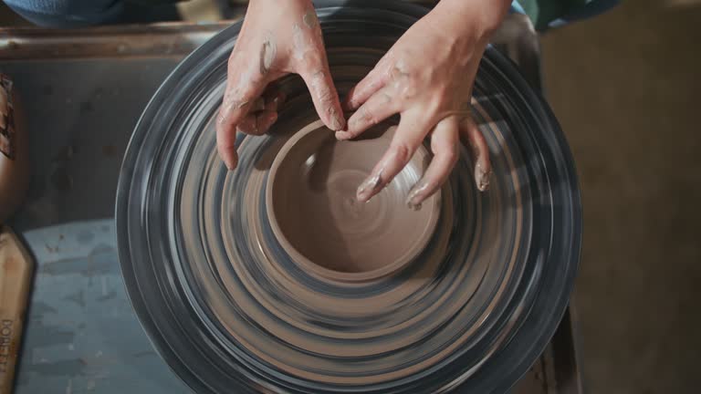 Close-up of woman's hands in pottery studio