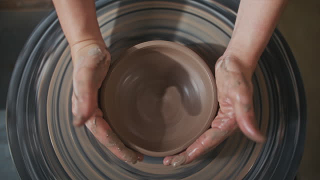 Young artist in the pottery studio making bowl with her hands, handmade creative artist, Small Business