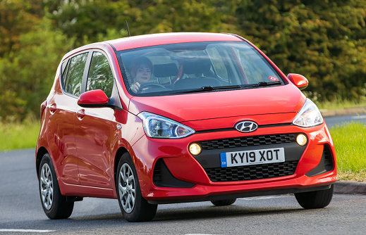 Stony Stratford,UK - June 4th 2023:  2019 red HYUNDAI I10 SE car travelling on an English country road