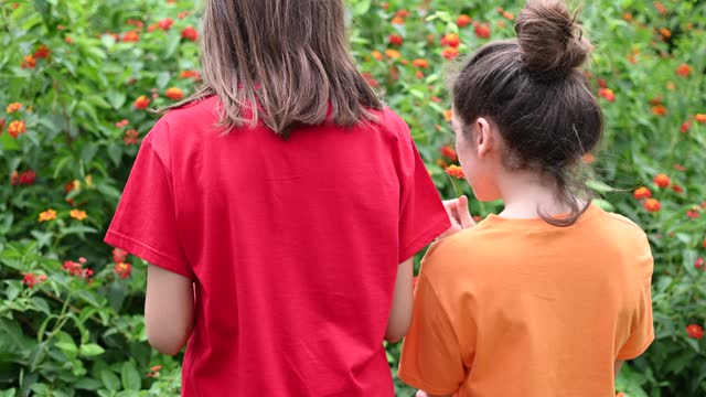 Beautiful Little girls enjoying to garden, red and orange concepts