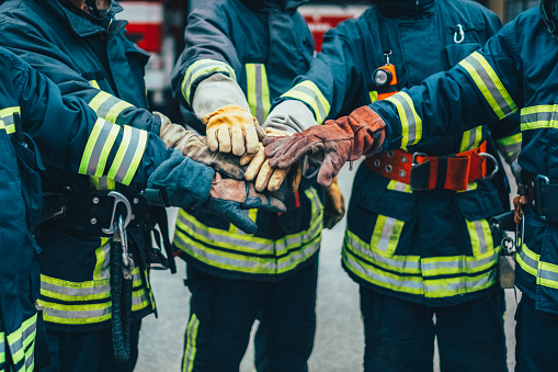 Firefighters with hands stacked