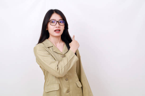istock Wow expression face of young indonesian civil servant worker standing while pointing behind 1497672714