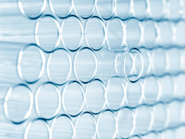 Close up of a group of plastic test tubes on a metal grating surface