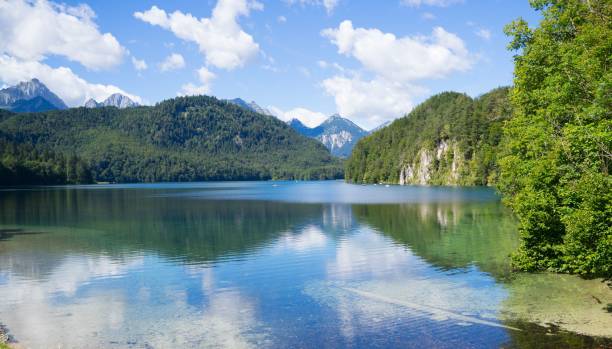 istock Scenic landscape featuring a lake surrounded by lush greenery with mountains in the background 1497677398