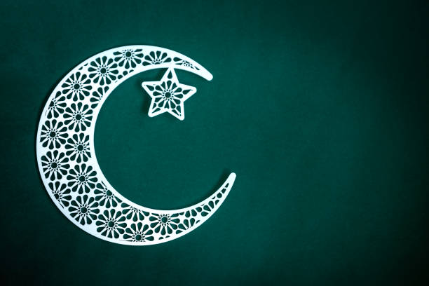 istock Crescent moon with star isolated on green background 1497677538