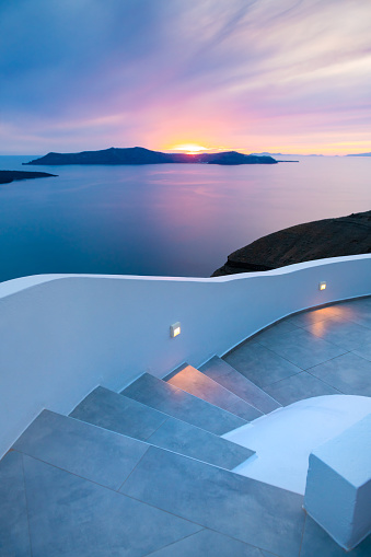 Night lights at sunset in Santorini island, Greece. White architecture with sea view in Fira town. Summer travel and vacation