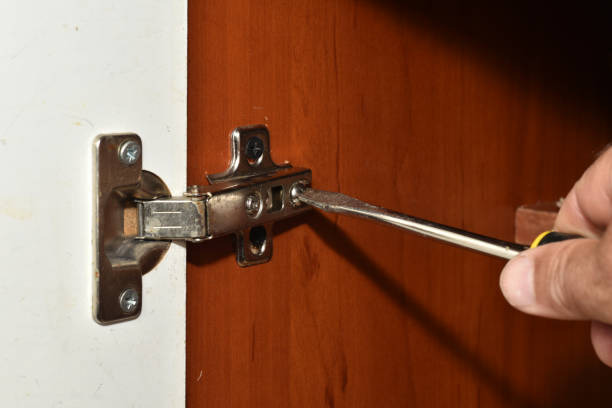 istock The worker's hand that holds a screwdriver, which unscrews the bolt. 1497679095