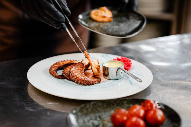 istock Confident male chef garnishing a plate in commercial kitchen 1497679593