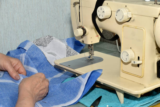 istock The seamstress works at the sewing machine, she connects the details. 1497680749