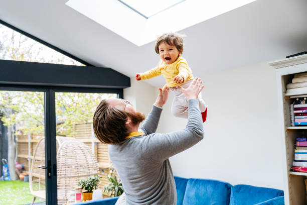 istock Father playing with toddler son throwing him into the air 1497682525