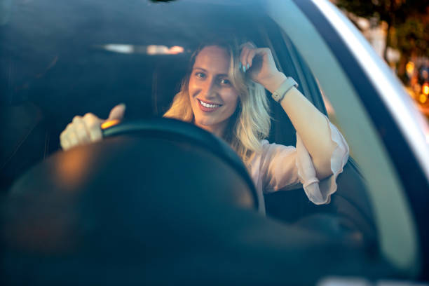 istock Cheerful blonde woman driving a car 1497682707