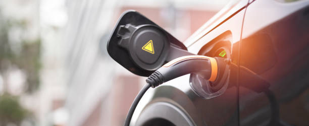 istock Hybrid car at the charging station 1497684115