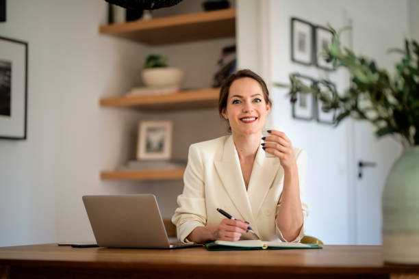 istock Young businesswoman using laptop and working from home 1497684574