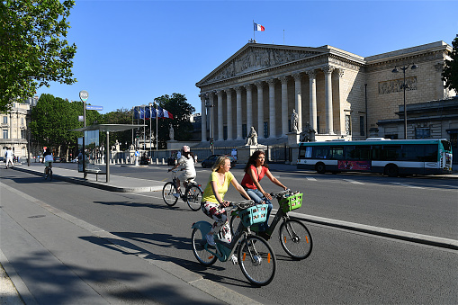 Paris, France-05 28 2023: Cyclists in front of the building of the French national assembly, Paris, France.