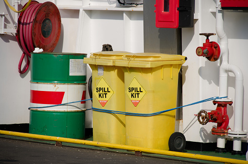 Spill kit yellow wheelie bin for health and safety of chemical, oil, diesel or petrol pollution leak UK