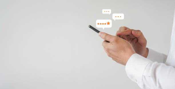 istock close up on customer man hand pressing on smartphone screen with gold five star rating feedback icon and press level three rank (good) for give score point to review the service business concept 1497687867