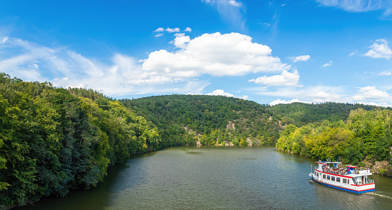 Panorama of a natural body of water in a forest landscape. Brno Reservoir.