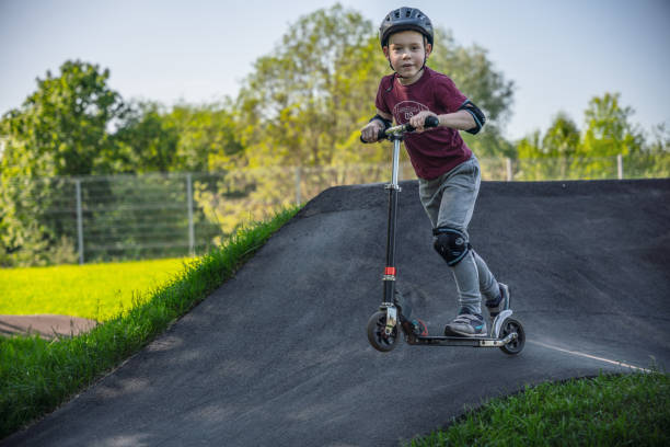 istock Boy riding push scooter at the outdoors pumptrack 1497688083