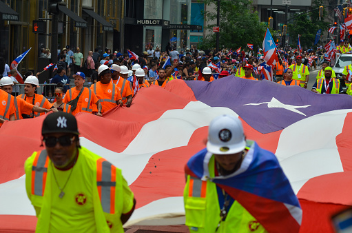 A giant Puerto Rican flag is seen on Fifth Avenue, New York City during the 66th annual Puerto Rican Day Parade.