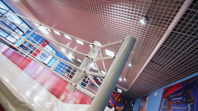 Corner of boxing ring with soft ropes in fighting gym