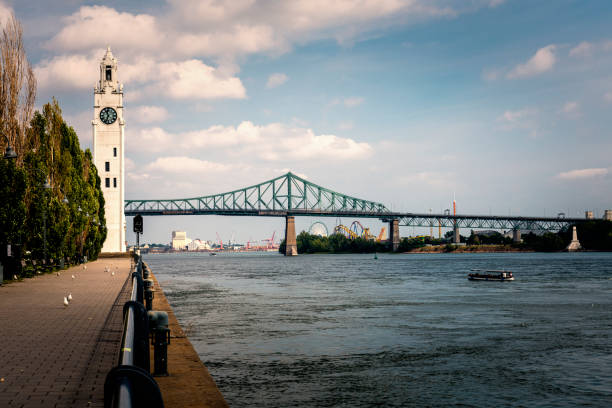 istock Jacques Cartier bridge over St. Lawrence River and a clock tower in Montreal in Canada 1497692193