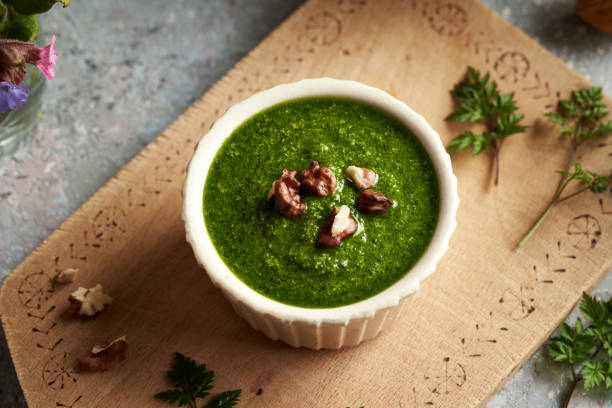 Pesto sauce made of cow parsley or Anthriscus sylvestris plant A bowl of green pesto made of young cow parsley leaves - wild edible plant collected in early spring cow parsley stock pictures, royalty-free photos & images
