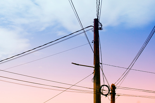 Electricity pylon, cables. Sunset sky background, pink color . Galicia, Spain.