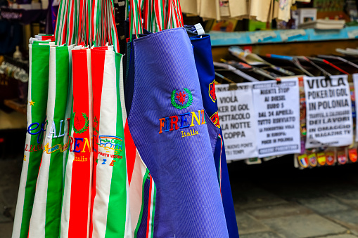 Florence, Italy - April 14, 2023: Colorful kitchen aprons are displayed outside the market stall, which also offers other souvenirs from this wonderful city.