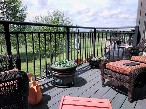 Residential backyard deck overlooking lawn and lake