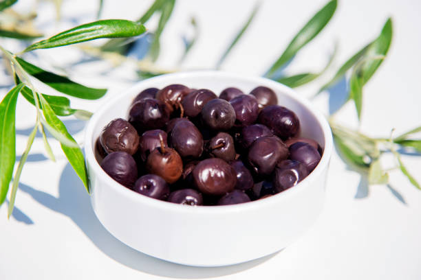 istock Close-up of black olives on white background 1497702855