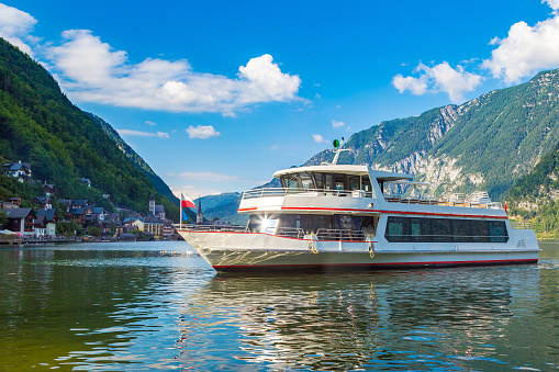 Cruise boat on Hallstatt lake, Salzkammergut, Alps, Austria in a beautiful summer day