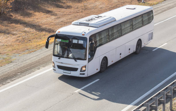 istock Bus moves along a country road. 1497709676