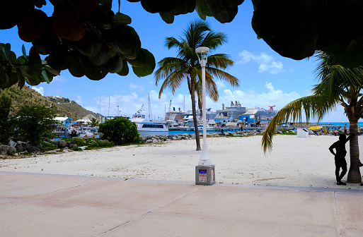 Saint Maarten — March 28, 2019: Cruise ships docked at Saint Maarten cruise ship port. Person in silhouette in shade.