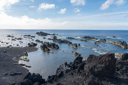 View on volcanic rock protruding out of the sea, close to the Mosteiros on Sao Miguel, Azores